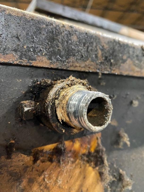 Blodgett pizza oven showing a worn, dirty gas connection, indicating heavy use and potential maintenance needs.