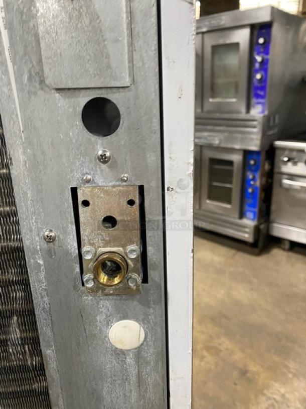 Scotsman Prodigy Series ice machine C0330SA-1C/B330P side panel view, showing exposed components, in warehouse setting.