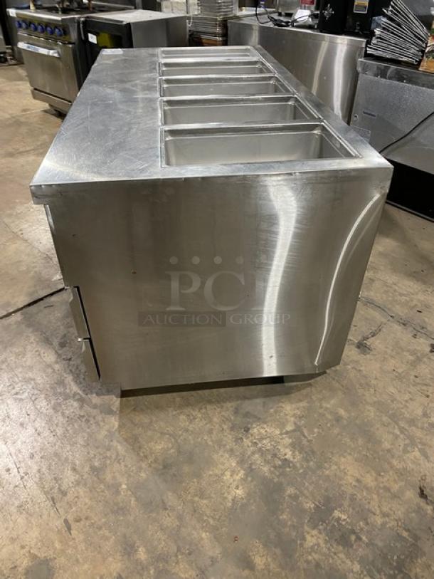 Delfield stainless steel 4-drawer refrigerated prep table, model 18MC72P13, on casters. Used condition.