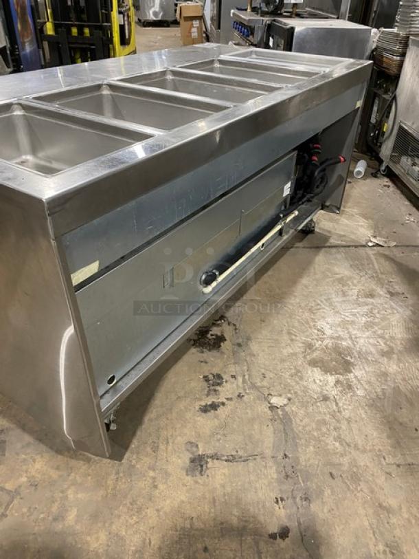 Delfield stainless steel refrigerated prep table, model 18MC72P13, 4 drawers, on casters, 115V, with visible wear.