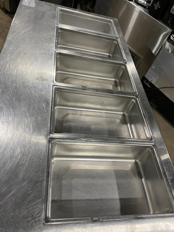 Delfield Commercial Stainless Steel 4 Drawer Refrigerated Prep Table, Model 18MC72P13, features multiple food pans on top.