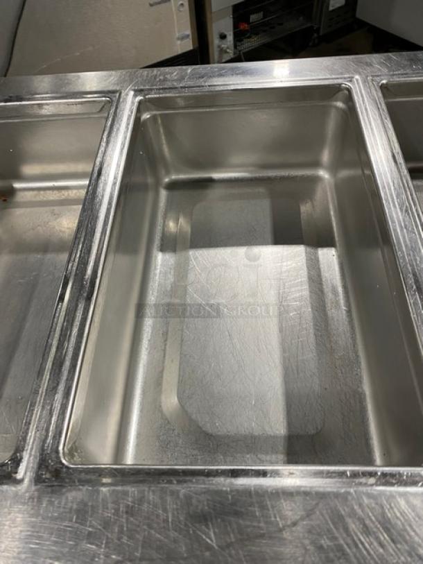 Delfield stainless steel prep table, 4 drawers, refrigerated, model 18MC72P13, on casters, good condition.