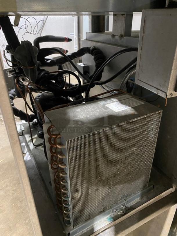 Inside view of a Delfield Commercial Refrigerated Prep Table, showing mechanical components and wiring. Model: 18MC72P13.