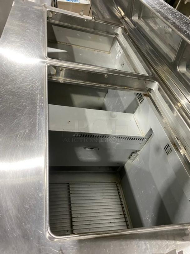 Randell 9040K7 stainless steel refrigerated prep table with 2 doors, poly coated rack, on casters, 115V 1 Phase.