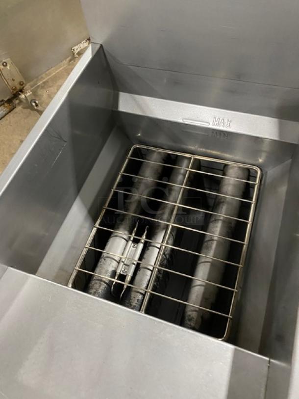 Globe GFF35G stainless steel gas deep fryer, showing interior heating elements, in used condition, with back splash.