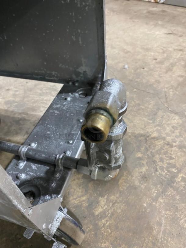 Globe GFF35G fryer gas line connection on metal base, showing casters and wear. Natural gas powered.