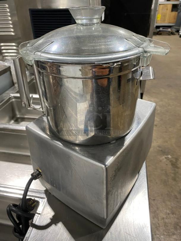 Robot Coupe R602VV food processor with 7 qt stainless steel bowl, glass lid, 120V 1 Phase, on legs, in good condition.