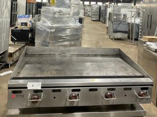Wolf commercial stainless steel natural gas countertop flat griddle with back and side splash, on legs, used condition.