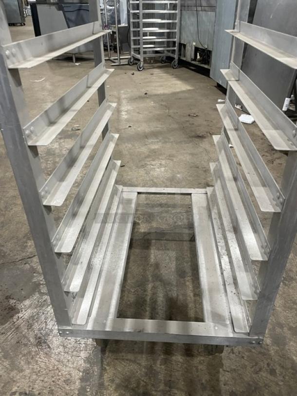 Commercial aluminum pan holding/transport rack on casters, multiple shelves, good condition, ideal for kitchen use.