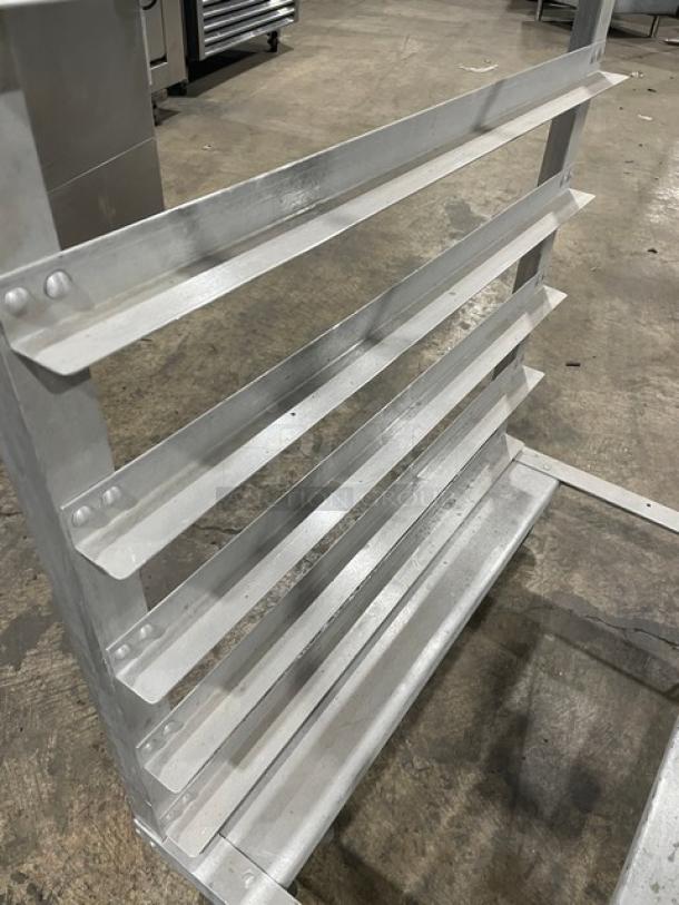 Commercial aluminum pan holding/transport rack on casters, features multiple shelves, sturdy construction, industrial use.