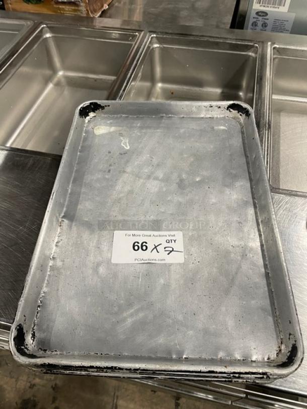 Commercial full-size sheet pan, used condition, metal with worn edges. Tag indicates "66 X 7" for auction details.