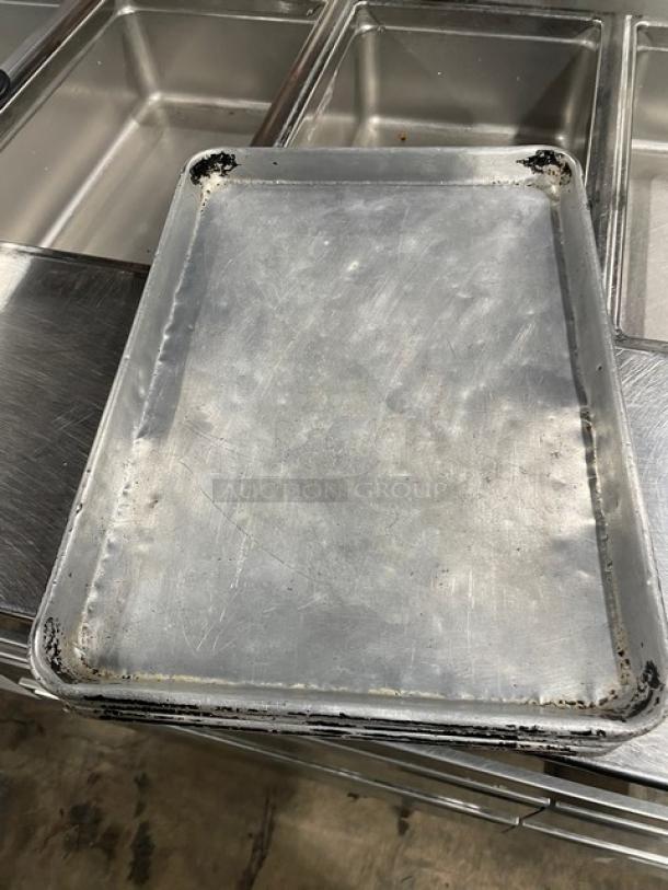 Commercial full-size sheet pan with visible wear and patina, ideal for baking. Heavy-duty construction for professional use.