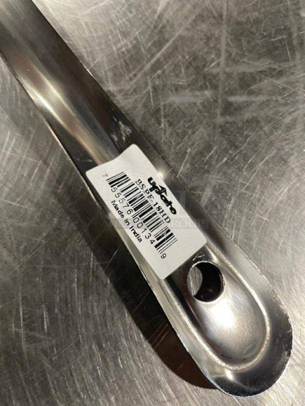 Brand new 18" Update International BSPF18HD stainless steel perforated basting spoon, barcode label visible, made in India.