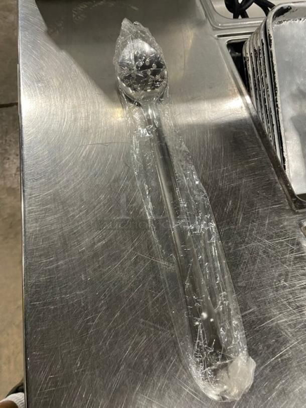 Brand new Update International 18" perforated basting spoon, model BSPF-18HD, in stainless steel, wrapped in plastic.