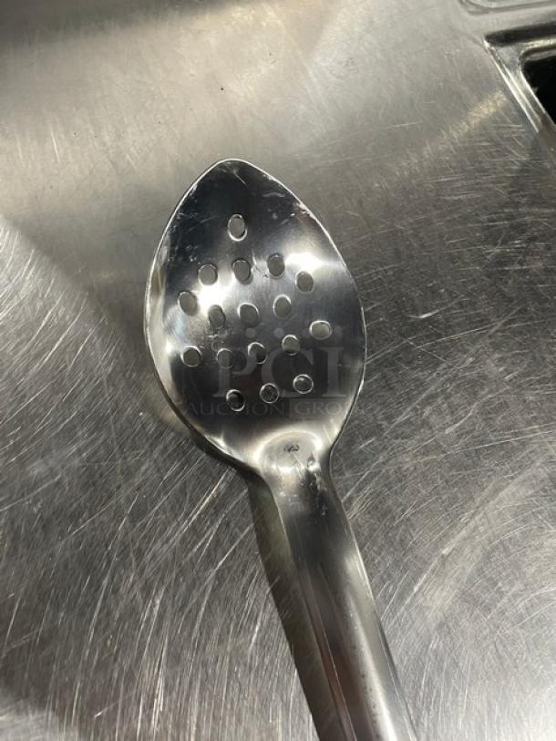Brand new Update International BSPF18HD 18" perforated stainless steel basting spoon on metallic surface.