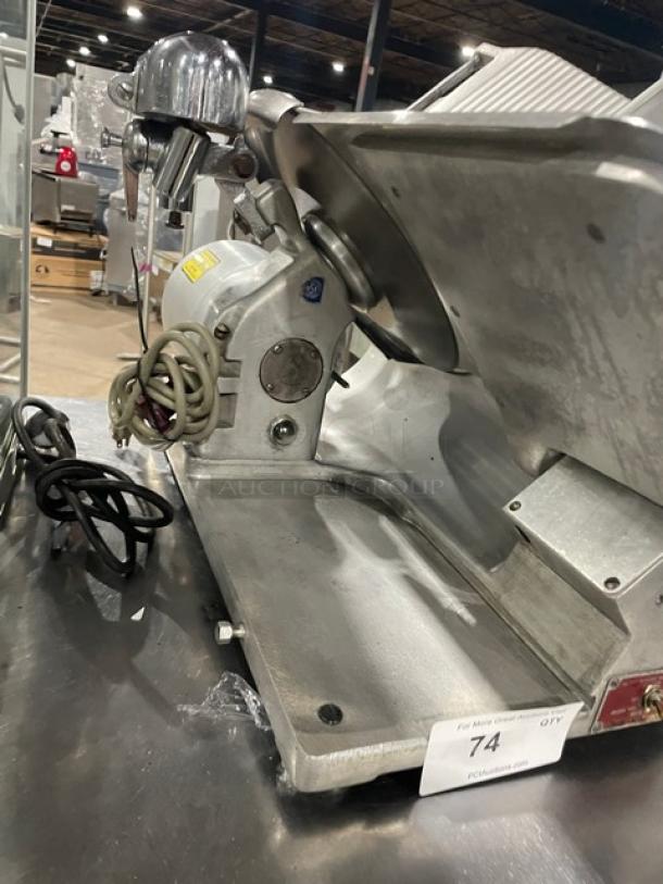 Globe Model 400 heavy-duty electric meat slicer on legs, showing blade, motor, and power cord. Used condition.