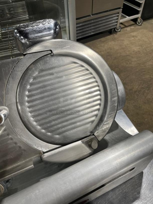 Globe Model 400 commercial electric meat slicer, heavy-duty, stainless steel, countertop design, on legs, good condition.