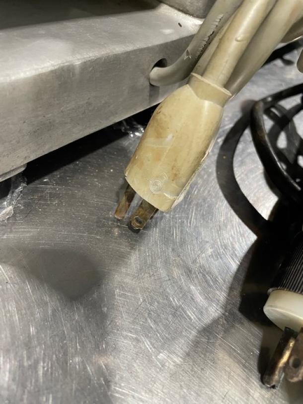 Globe Model 400 countertop electric deli slicer power plug. Heavy-duty design, visible aging, suitable for commercial use.