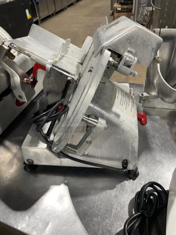 Fleetwood electric deli slicer on legs, heavy-duty, countertop model, used condition with visible power cord and adjustment knobs.