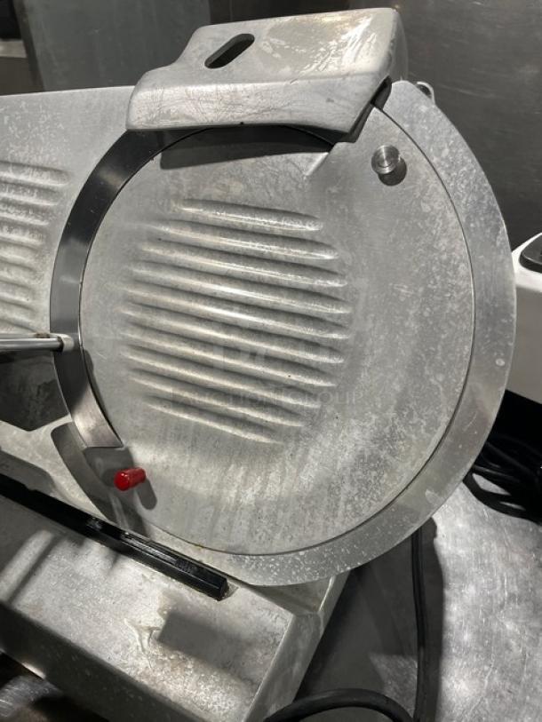 Fleetwood commercial electric meat slicer, heavy-duty, countertop model, mounted on legs, in used condition.