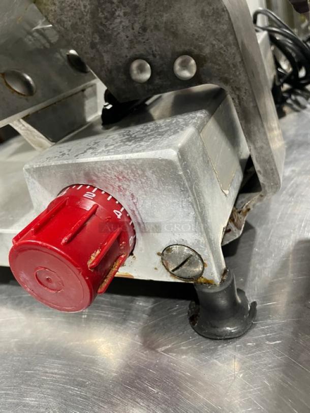 Fleetwood heavy-duty meat slicer, electric countertop model, with adjustable red knob and sturdy metal legs.