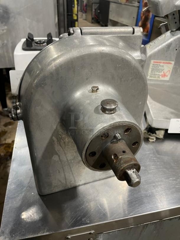 Commercial heavy-duty pelican-head slicer/shredder/grater mixer attachment, stainless steel, used condition, industrial setting.