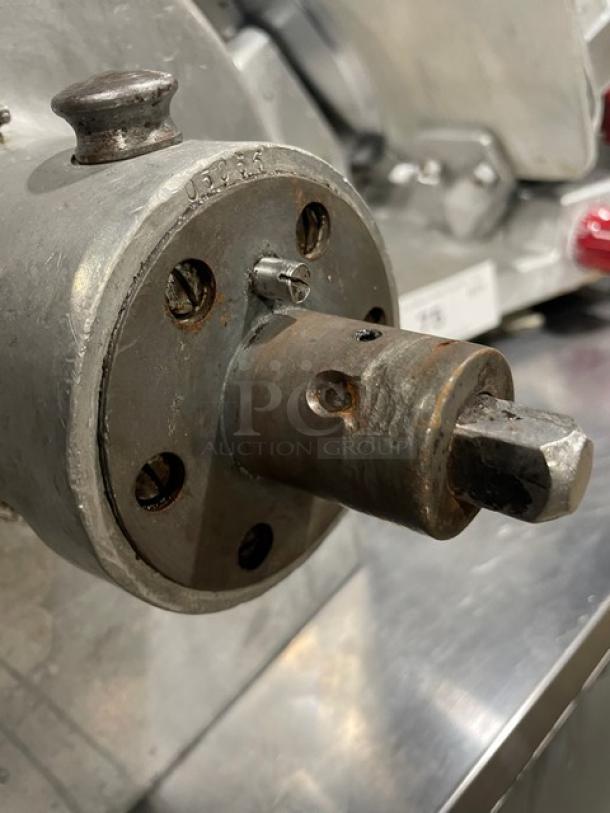 Heavy-duty Pelican-Head slicer/shredder/grater mixer attachment, metal construction, visible wear, sturdy build.