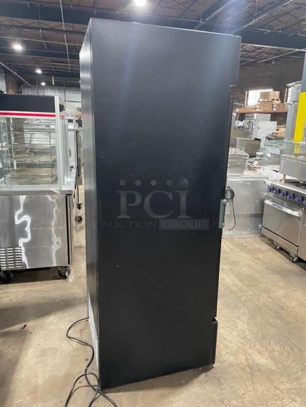 QBD Cooling Systems black single glass door merchandiser refrigerator, Model CD26HB, with poly-coated wired rack, 115V 1 Phase.