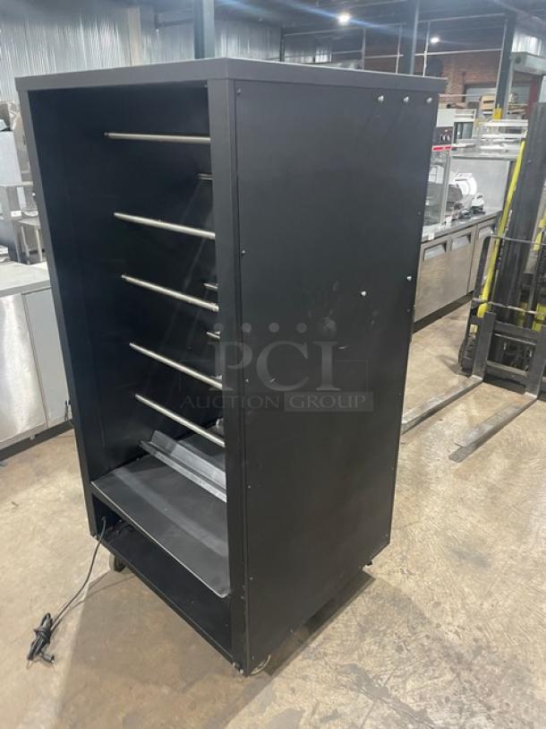 Vulcan 5-tier black bakery merchandiser display with stainless steel interior, lighted shelves, enclosed storage, on casters.