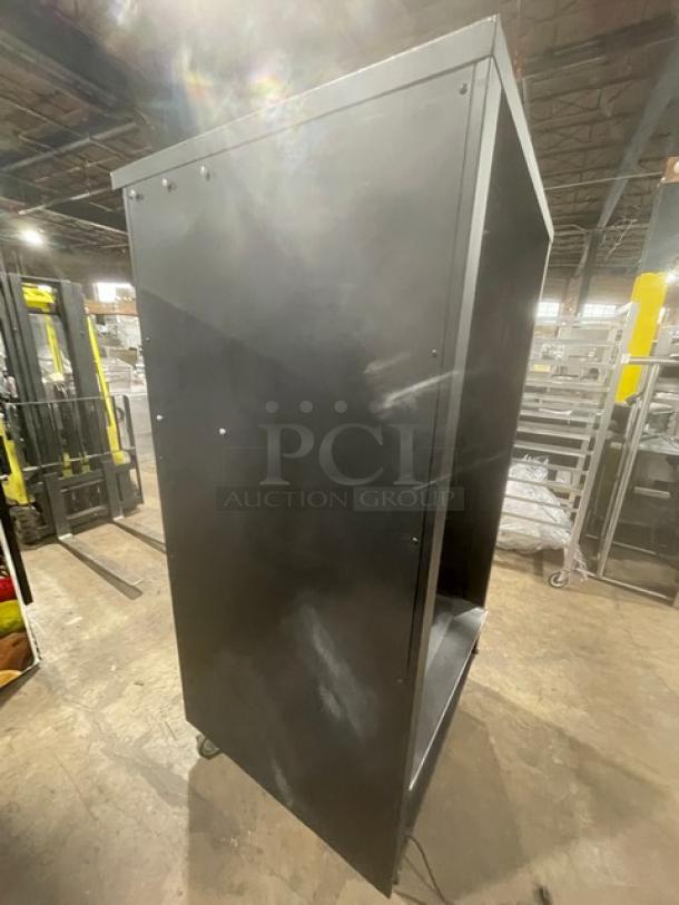 Vulcan black 5-tier bakery display case with lighting, stainless steel interior, enclosed storage, and casters. Used condition.