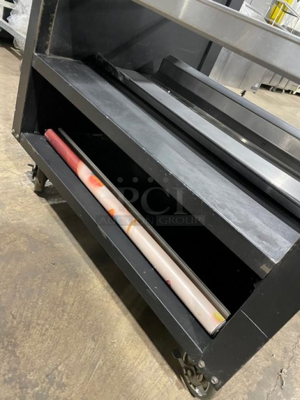 Vulcan black 5-tier lighted bakery merchandiser, stainless steel interior, enclosed storage, on casters, good condition.