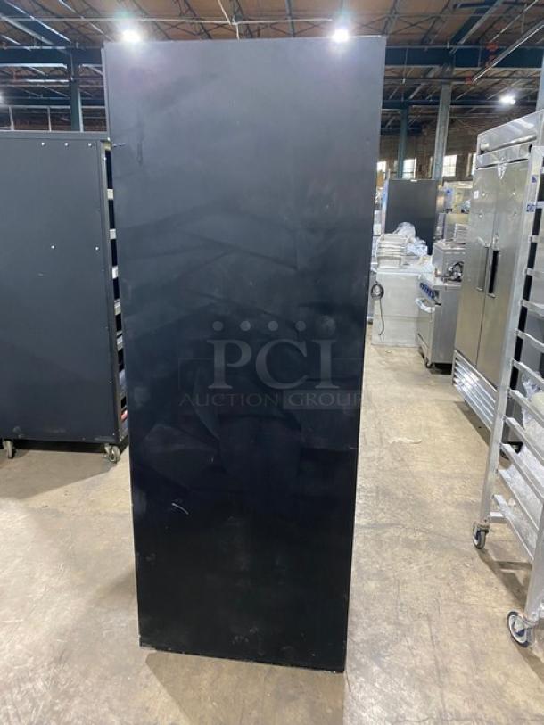 True GDM-37 commercial refrigerator, black with double glass sliding doors, poly-coated wire racks. Model GDM-37, SN 1-4753863.