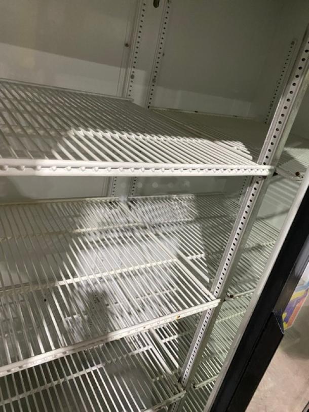 True Commercial Black Double Glass Sliding Door Merchandiser Refrigerator, Model GDM-37, with poly-coated wired racks.