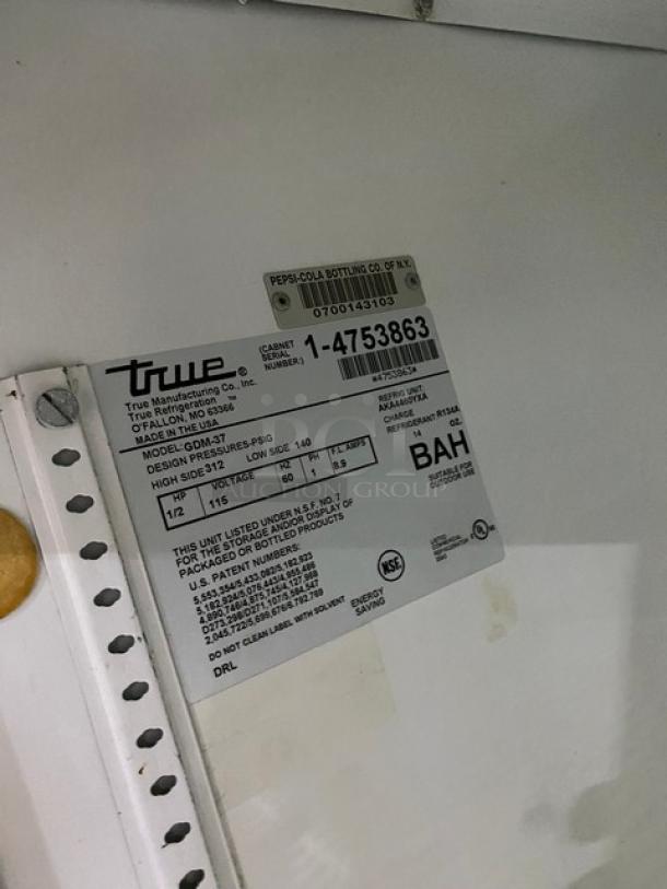 True commercial refrigerator label, Model GDM-37, SN: 1-4753863, 115V, 1 phase, NSF listed, and poly-coated racks indication.