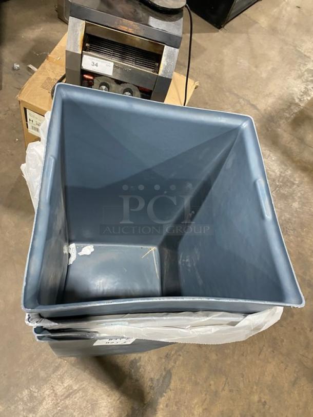 Commercial large square gray trash can, durable plastic, stacked with additional bin. Slight wear, ideal for high traffic use.