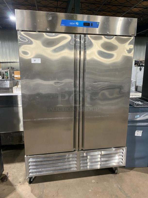 Asber commercial stainless steel double swing door freezer with poly coated wire rack, Model ARF49HFHC, 115V 1 Phase, on casters.