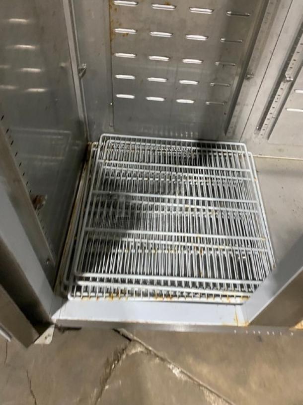 Hoshizaki stainless steel reach-in refrigerator interior with poly-coated wire rack, Energy Star certified, on casters.