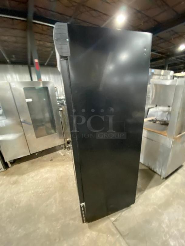 Ojeda FMH27 commercial swing door refrigerator, black exterior, poly-coated wire rack, 120V, visible side view.
