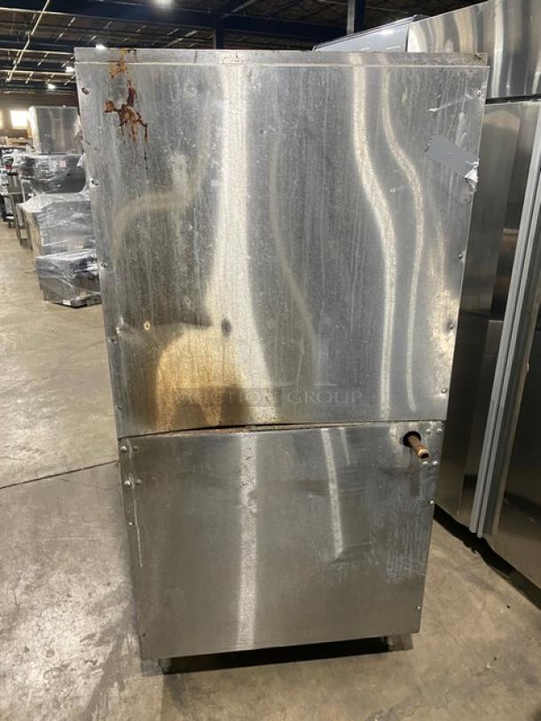 Garland Commercial Stainless Steel Range & Oven Combo in worn condition; features 2 burners, flat plate, and salamander broiler.