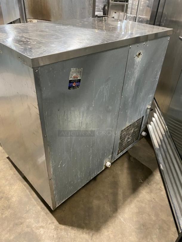 Hoshizaki stainless steel undercounter ice machine, electric, sliding door, on legs, visible wear, commercial use.