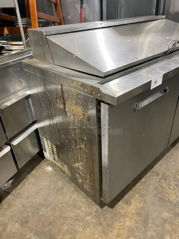 Kelvinator KCHMT60.24 stainless steel 2-door refrigerated prep table on casters. Shows surface wear and rust on sides. Model KCHMT60.24, SN: 01420008, 115V.