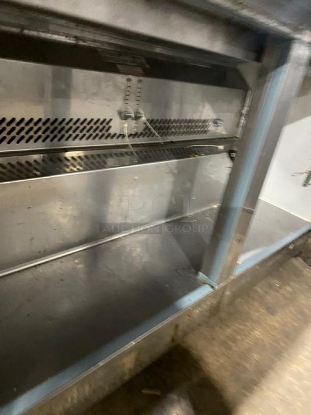 Kelvinator KCHMT60.24 stainless steel 2-door refrigerated prep table; bain marie style; on casters; interior view.