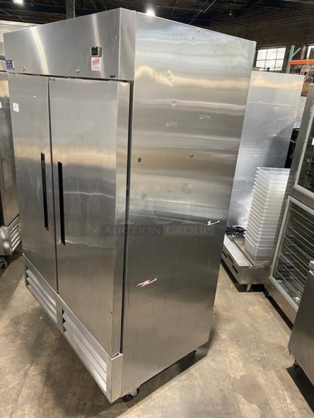 Arctic Air AF49EX stainless steel 2-door reach-in freezer on casters, poly-coated racks, 115V, model and serial tags visible.