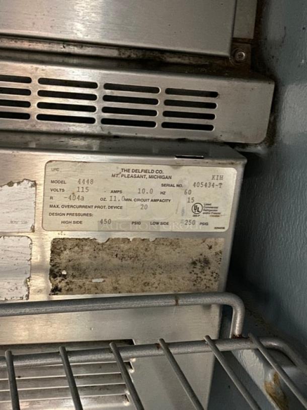 Delfield stainless steel undercounter refrigerator, model 4448, with wired rack, 115V. Visible serial label: 405434-T.
