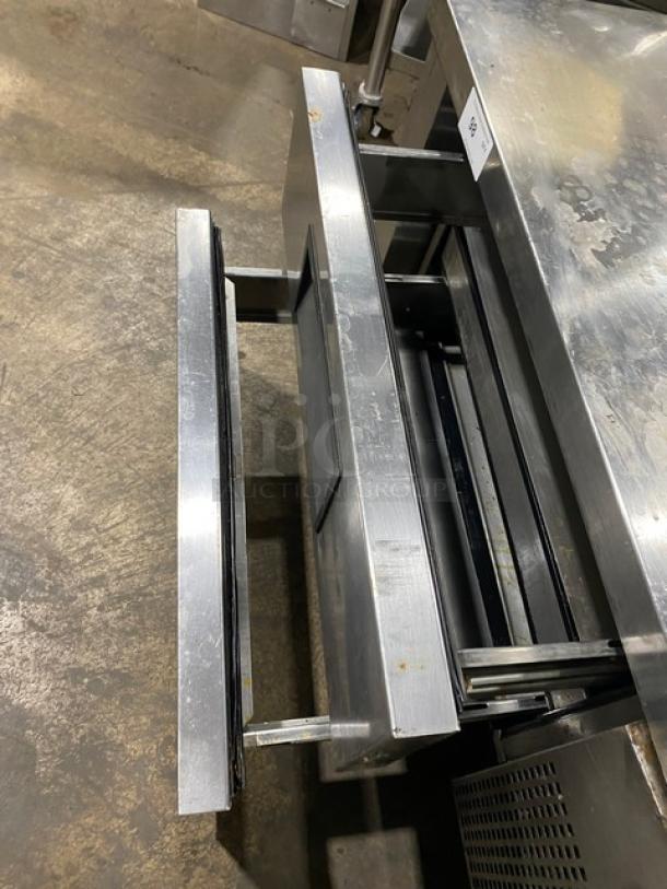 Commercial stainless steel 2-drawer refrigerated chef base on casters, shown in good condition with visible wear signs.