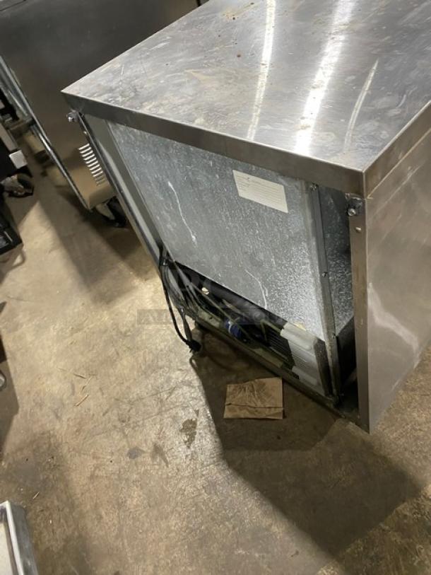 Randell stainless steel undercounter refrigerator on casters, poly coated wire rack, single solid door, commercial-grade.