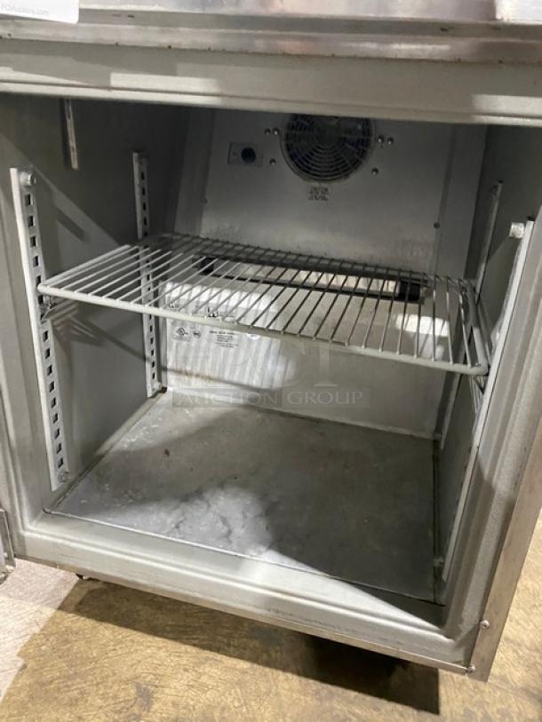 Randell commercial undercounter refrigerator, stainless steel, single door, with poly coated wire rack, on casters.