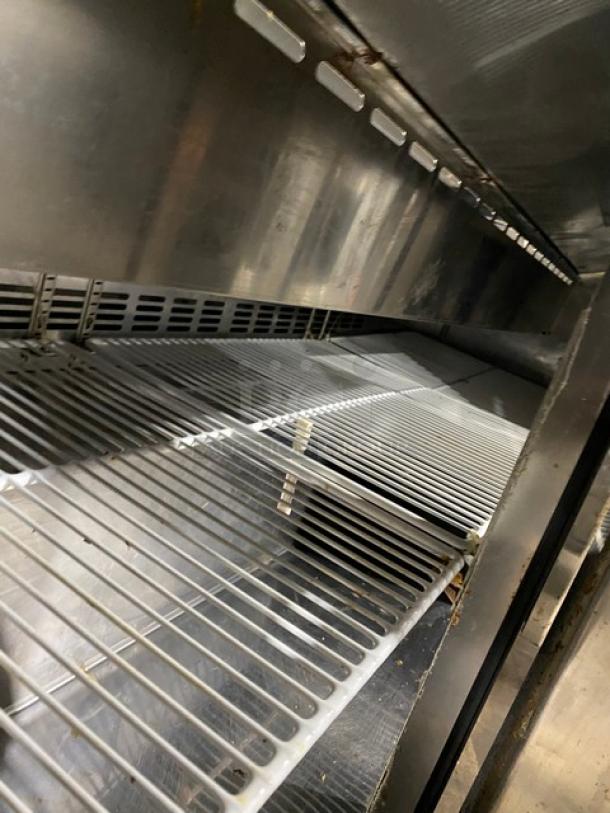 Blue Air 3-door stainless steel refrigerated prep table, model BAPT72, with a cutting board and poly-coated wire rack.