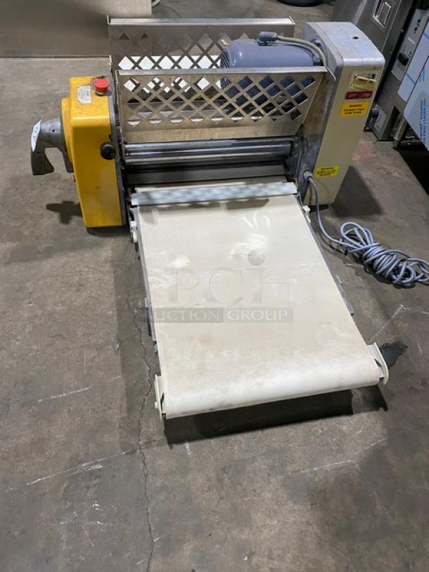 Anets commercial electric countertop conveyor-belt dough roller/sheeter machine, used, visible power cord, safety labels.