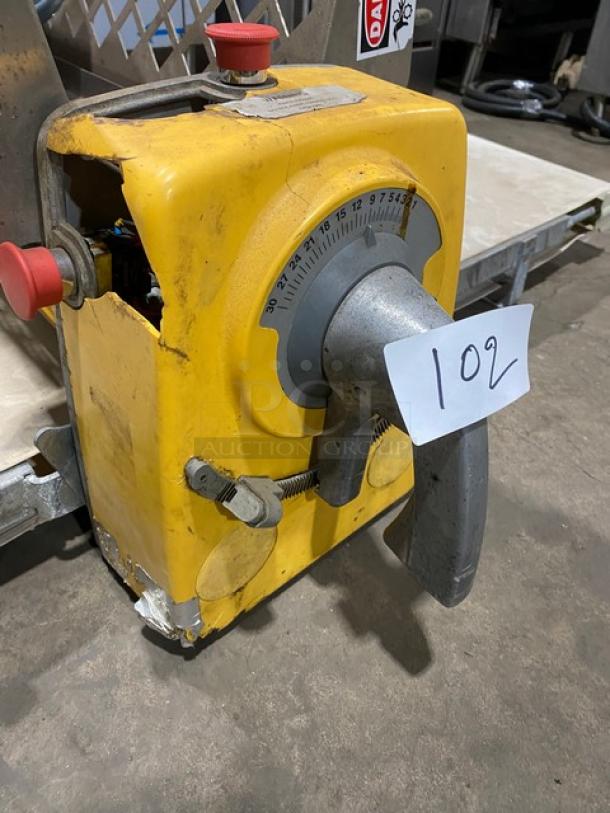 Anets commercial electric countertop conveyor-belt dough roller machine, yellow, with visible wear and adjustment dial.